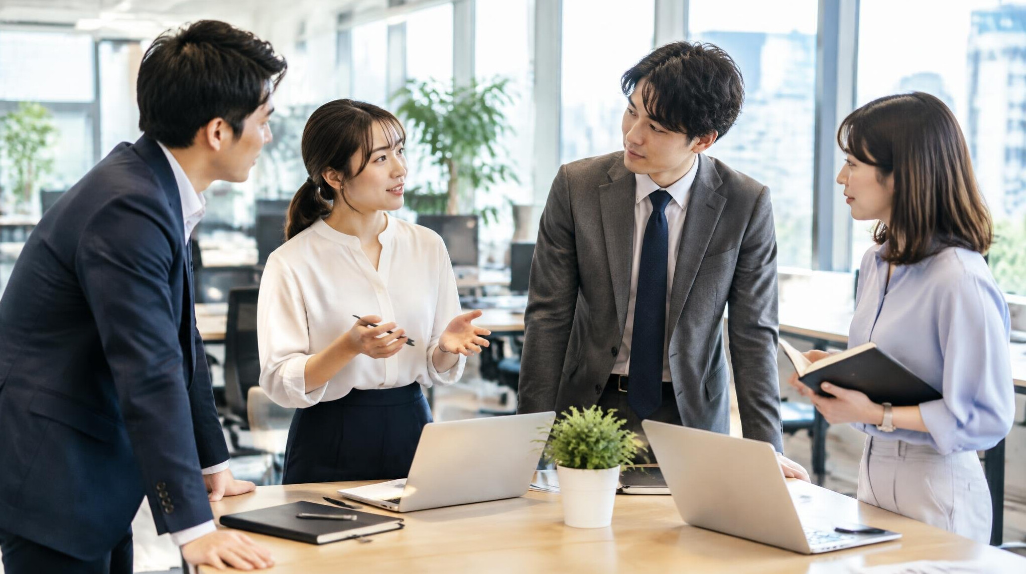 Japanese office team having a discussion in a bright workspace